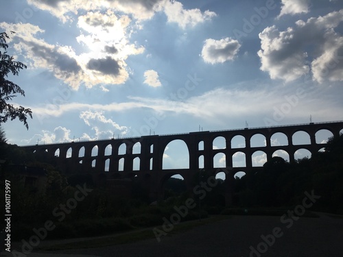 Historic Viaduct Silhouette against Cloudy Sky photo