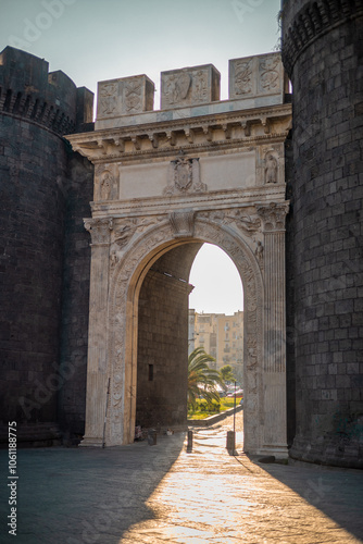 Obraz na płótnie Beautiful evening photo with strong sunshine backlight of Porta Capuana entrance gate to the old town of Napoli old town. Magnificent roman gate in Naples.. w salonie