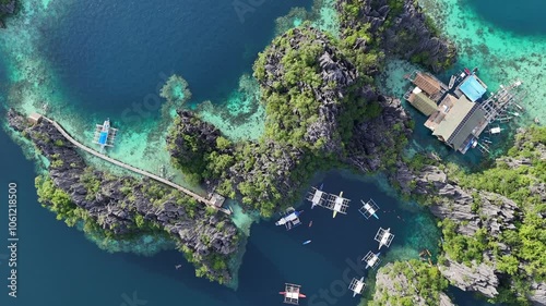 Stunning Aerial 360° Sunset View of Twin Lagoon and Surrounding Islands on Coron, Philippines – Turquoise Waters, Boats, and Lush Cliffs in 4K Drone Footage
