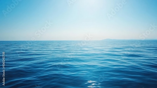 A vast, endless expanse of blue ocean water under a clear, sunny sky.