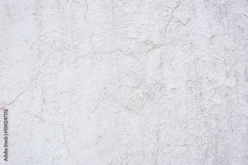 White concrete wall with natural defects. Fragment of the cement surface with natural texture. Monochrome palette of shades.