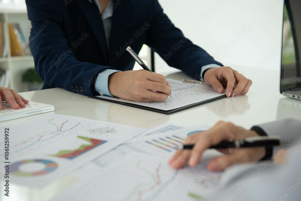 Business and Financial concept. Business team discussing assessment and evaluation of corporate showing the results of their successful teamwork. Business and Financial concept. Business team discussing assessment and evaluation of corporate showing the results of their successful teamwork.