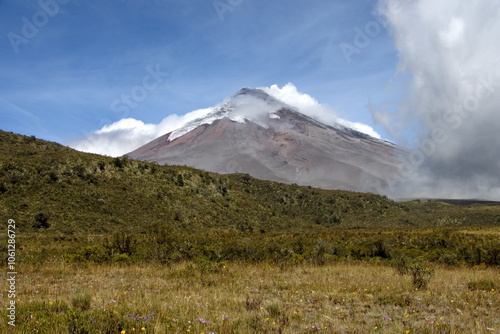 Clouds blowing towards Cotopaxi Volcano erupting with a small ash plume in Cotopaxi National Park, outside of Machachi, Ecuador