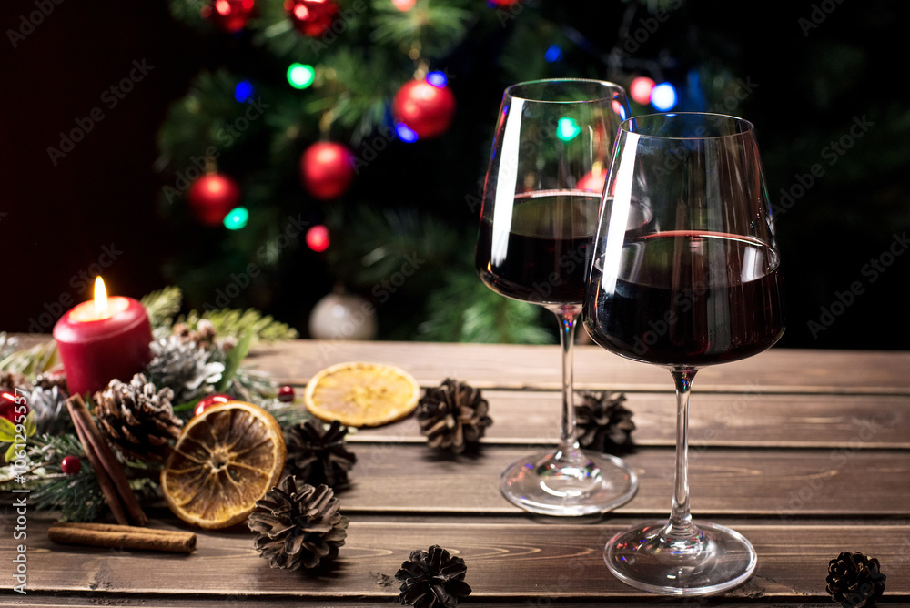 Glasses of wine on the background of a decorated Christmas tree. New year mood Glasses of wine on the background of a decorated Christmas tree. New year mood