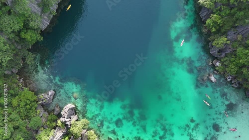 Stunning Aerial View of Twin Lagoon on Coron Island, Philippines – Turquoise Waters, Boats, and Lush Cliffs at Sunset in 4K Drone Footage