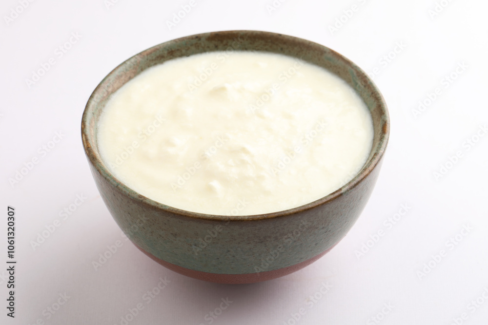 Homemade dahi doi or sour cream or curd or yogurt in a ceramic bowl. Curdled milk. Probiotic food or Probiotic dairy product. It is popular Indian dessert. Homemade dahi doi or sour cream or curd or yogurt in a ceramic bowl. Curdled milk. Probiotic food or Probiotic dairy product. It is popular Indian dessert.
