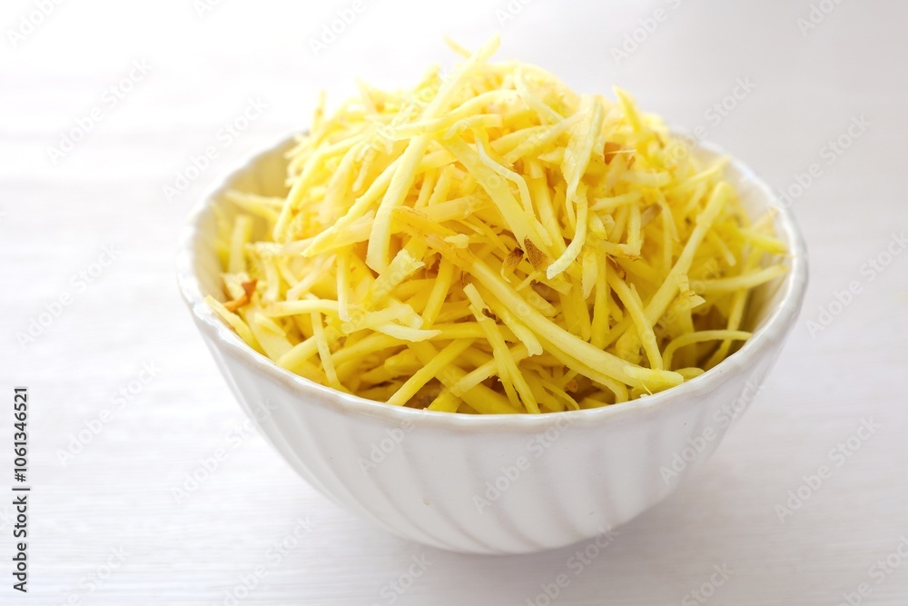 ginger slices in white ceramic bowl on white background ginger slices in white ceramic bowl on white background