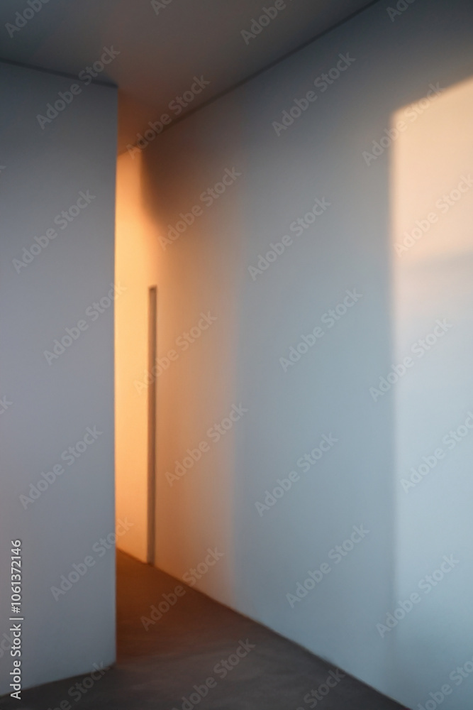 Minimalist empty hallway with soft warm light casting shadows on white walls Minimalist empty hallway with soft warm light casting shadows on white walls