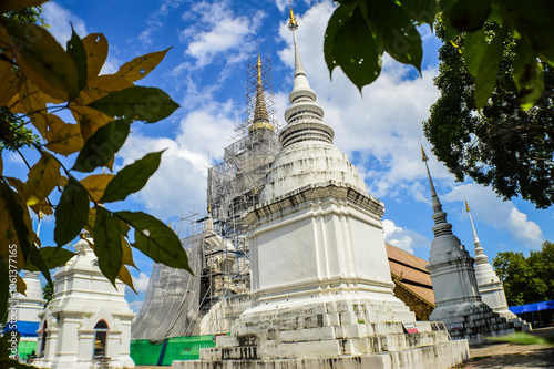 White Pagoda and Church, Lanna Architecture at Suandok temple, Symbols of Buddhism, Mueang Chiang Mai District, Chiang Mai Province, Northern Thailand, South East Asia photo