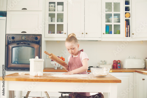 Baking, home and child in kitchen with dough for learning to bake cake, dessert and pastry. Development, culinary skills and young girl with ingredients, recipe and food for sweet treats on counter