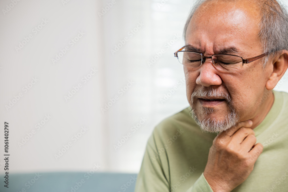 Retirement senior man feeling pain use hands holding neck and irritation in throat, Elderly people have dysphagia due to eating, Asian old man painful in sore throat, Health care and medicine concept Retirement senior man feeling pain use hands holding neck and irritation in throat, Elderly people have dysphagia due to eating, Asian old man painful in sore throat, Health care and medicine concept