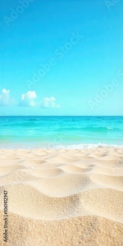 Sunny tropical beach with gentle waves and clear blue skies.