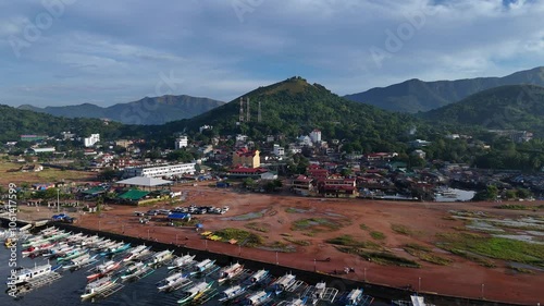 Breathtaking Drone Flyover of Coron Island with Mountain View and Waterfront Boats, Philippines – High-Resolution Aerial Footage