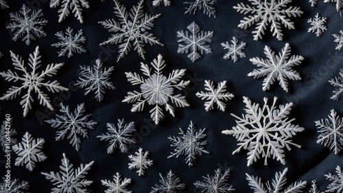 A detailed view of delicate snowflakes captured on a surface, showcasing their unique shapes and intricate patterns in a winter setting. photo