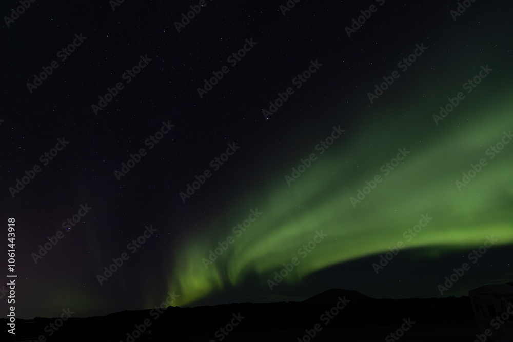 Aurora borealis over in the dark night. The dark sky and filled with stars Aurora borealis over in the dark night. The dark sky and filled with stars