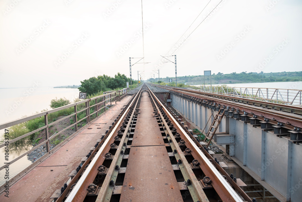 Fototapeta premium Railway track in India. Indian Railways Diesel-Electric Multiple Unit train