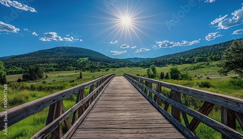 A wooden bridge stretches across a lush green landscape under a bright sun, inviting exploration and connection with nature.