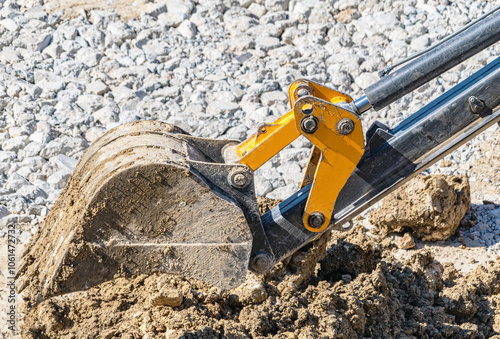 Excavator bucket filled with stones and pieces of concrete photo