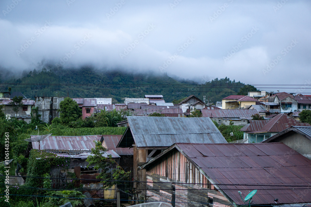 Landscape view of residents houses in Takengon city with mountain in the background. Takengon city at the morning Landscape view of residents houses in Takengon city with mountain in the background. Takengon city at the morning