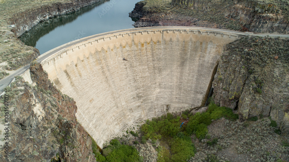 Aerial View of Majestic Concrete Dam in Rugged Canyon Aerial View of Majestic Concrete Dam in Rugged Canyon