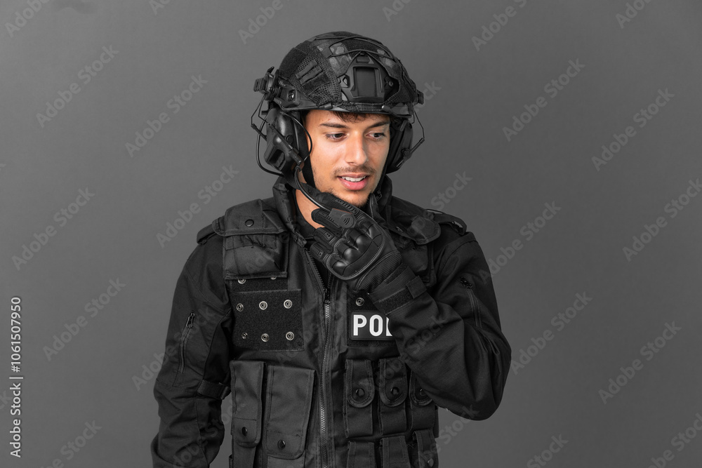 SWAT caucasian man isolated on grey background looking to the side SWAT caucasian man isolated on grey background looking to the side