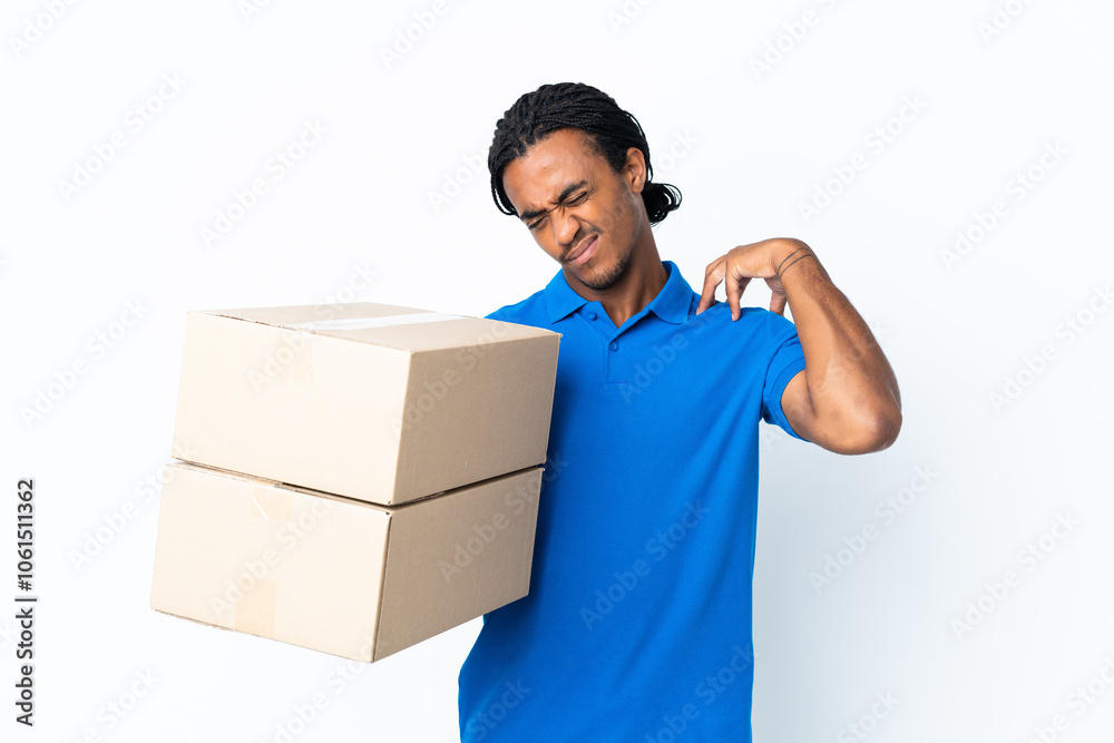 Delivery African American man with braids isolated on white background suffering from pain in shoulder for having made an effort Delivery African American man with braids isolated on white background suffering from pain in shoulder for having made an effort