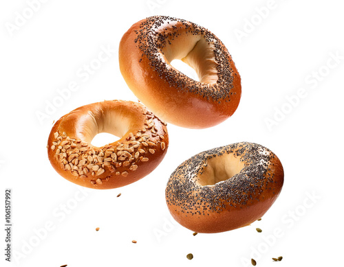 Three assorted bagels with sesame and poppy seeds, isolated on a white background.