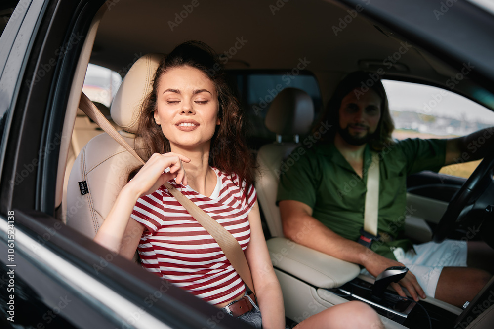 Smiling couple in a car, enjoying the ride with the woman in a striped shirt and the man in a green shirt, focusing on their relaxed expressions Smiling couple in a car, enjoying the ride with the woman in a striped shirt and the man in a green shirt, focusing on their relaxed expressions