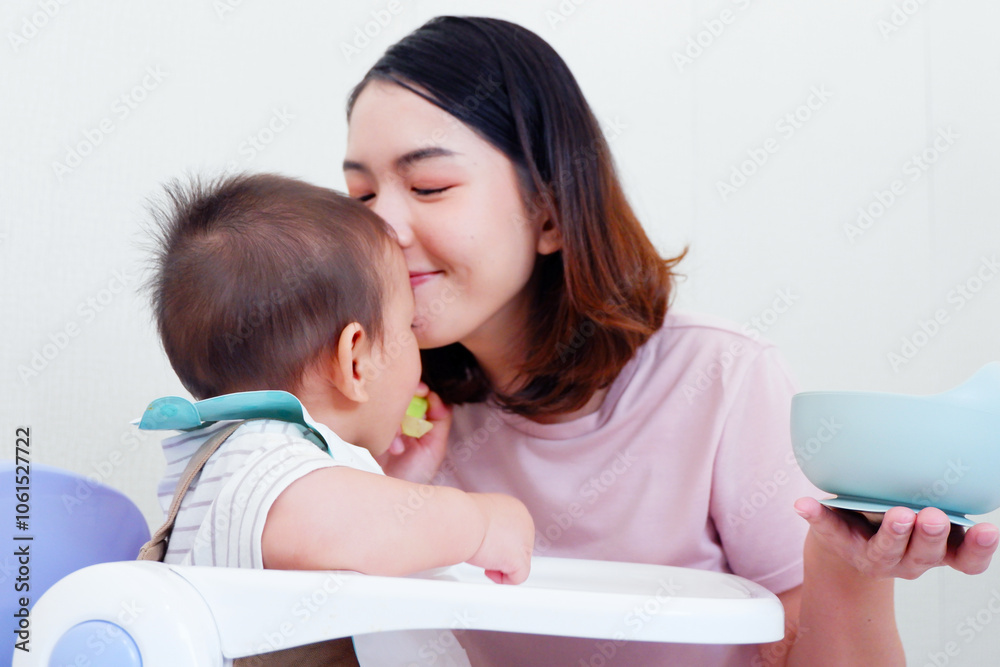 Mother and baby smiling and playing happily. Mother and baby smiling and playing happily.