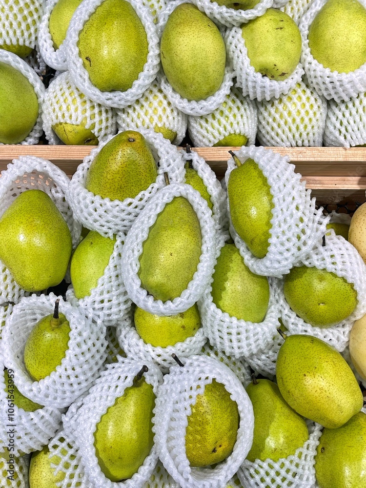 Lot of ripe fresh pears in net foam are sold at supermarket.
Pears with net foam in grocery store. Lot of ripe fresh pears in net foam are sold at supermarket.
Pears with net foam in grocery store.