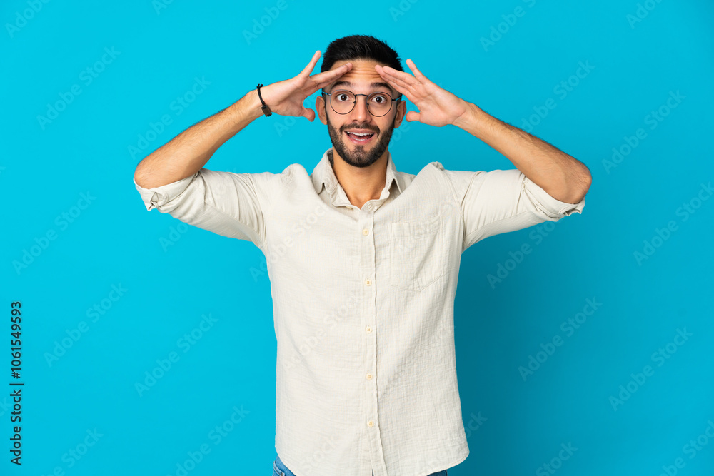 Young caucasian man isolated on blue background with surprise expression Young caucasian man isolated on blue background with surprise expression