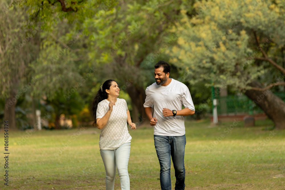 Indian couple running together in morning fitness routine Indian couple running together in morning fitness routine