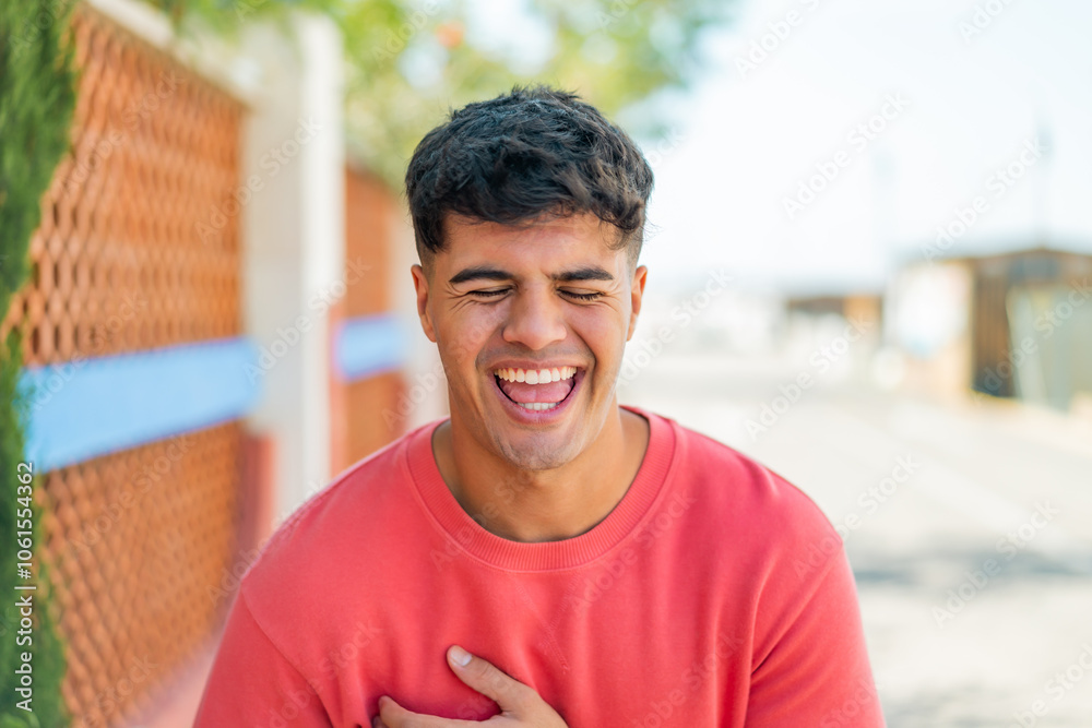 Young hispanic man at outdoors smiling a lot Young hispanic man at outdoors smiling a lot