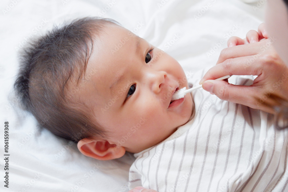 A baby or toddler is brushing his teeth and smiling. A baby or toddler is brushing his teeth and smiling.