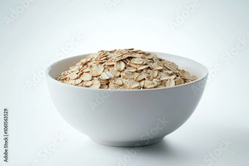 Oats in a bowl topped with fresh berries and honey, placed on a wooden table, surrounded by a spoon and a glass of milk.