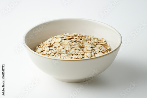 Bowl of oats on white background with blueberries, nuts, and honey drizzle.