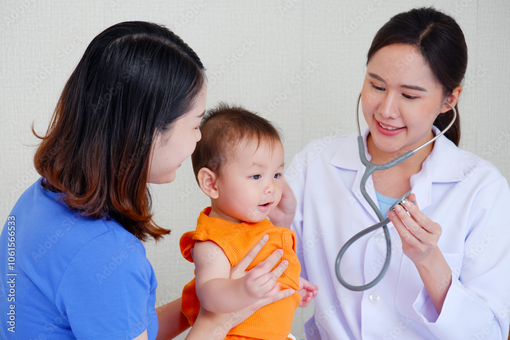 Female doctor examining a sick young child, Pediatrician concept. Female doctor examining a sick young child, Pediatrician concept.