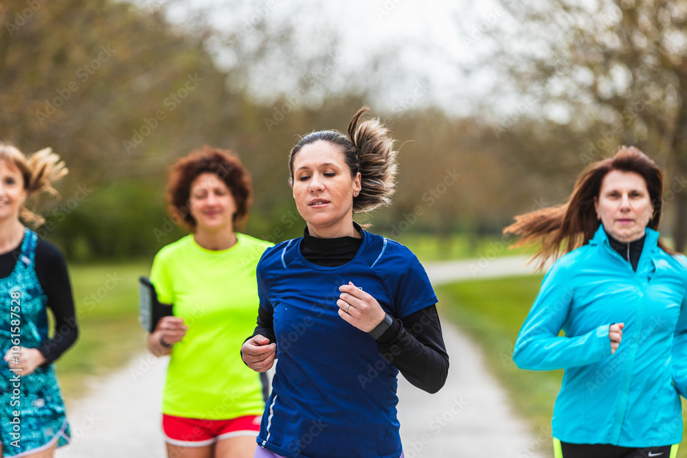 Group of women running together in a park Group of women running together in a park