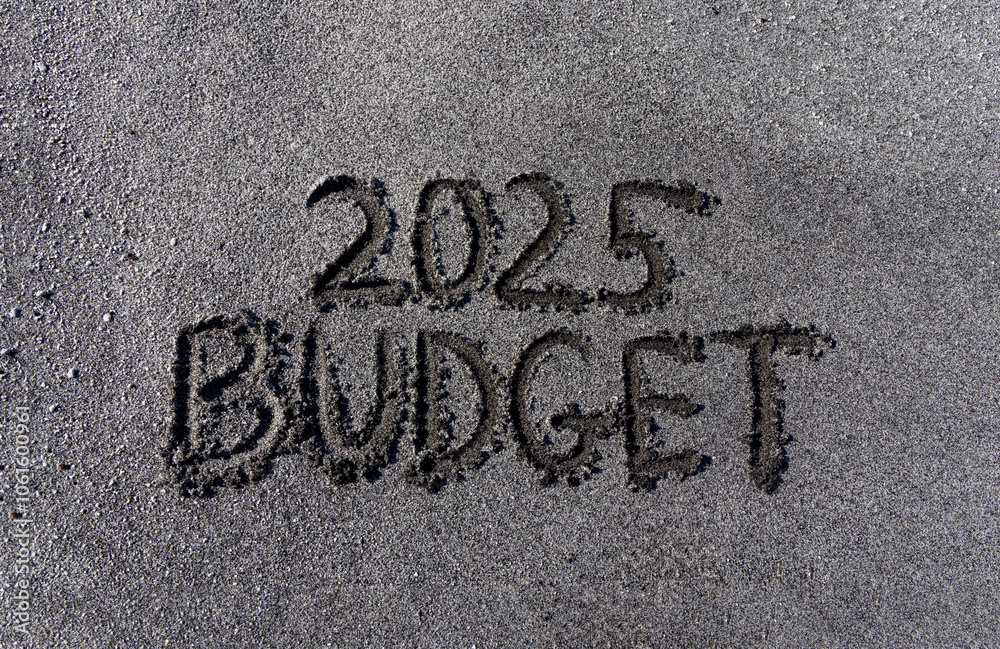 Planning budget 2025 new year symbol. Concept words Budget 2025 written on beautiful sand beach. Beautiful sand beach background. Business budget 2025 new year concept. Copy space. Planning budget 2025 new year symbol. Concept words Budget 2025 written on beautiful sand beach. Beautiful sand beach background. Business budget 2025 new year concept. Copy space.