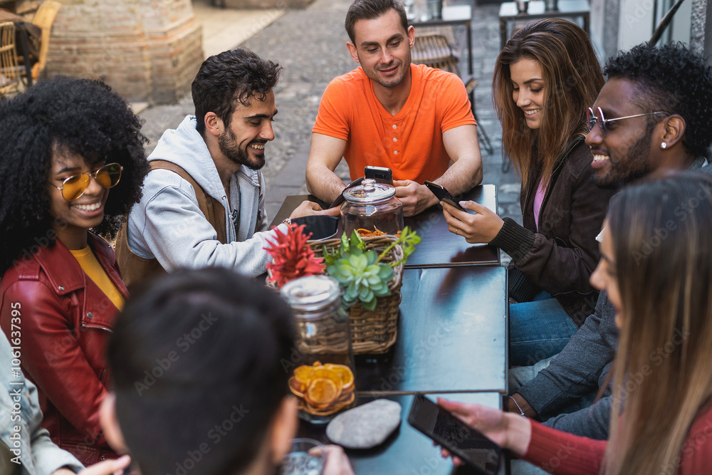 Diverse friends group using phones at social cafe terrace