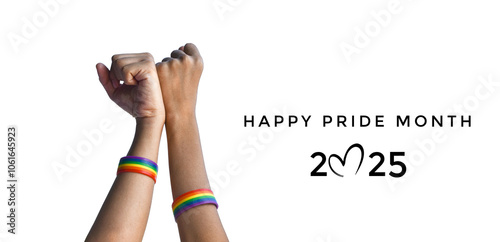 Happy Pride Month 2025 on rainbow wristband in hands raising background, concept for celebrations of LGBTQ+ people in pride month, June, around the world. photo