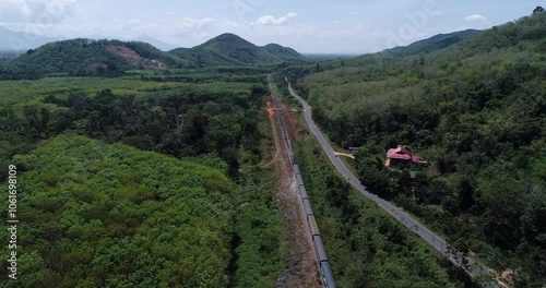 Aerial road through tropical rinforest green tree transport background photo