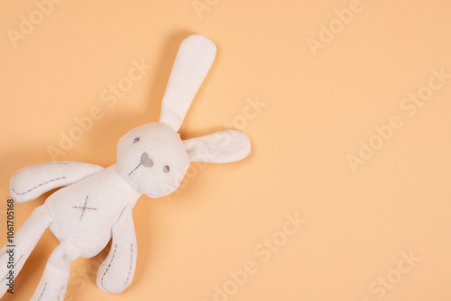 Quadro su tela Soft toy white hare handmade on beige background.