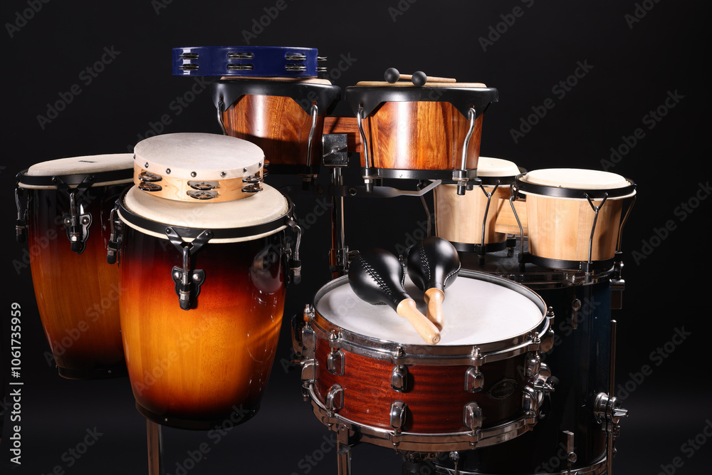 Different drums on a black background, percussion musical instruments Different drums on a black background, percussion musical instruments