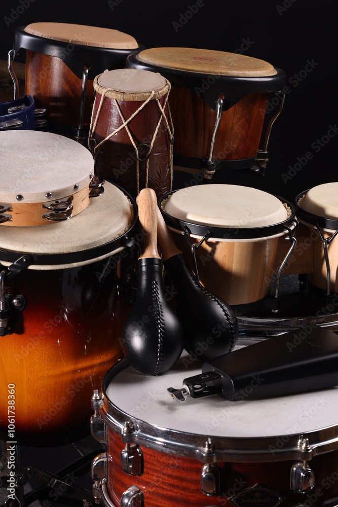Different drums on a black background, percussion musical instruments Different drums on a black background, percussion musical instruments