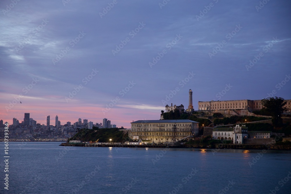 Naklejka premium Alcatraz island prison back lit in the sunrise