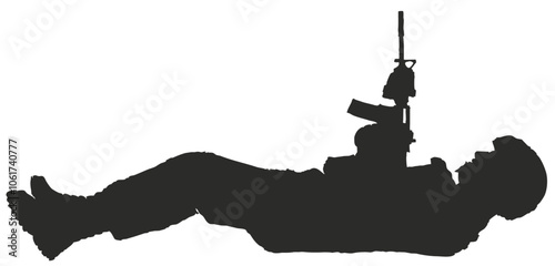 silhouette of a man lying down with his rifle pointed at the sky