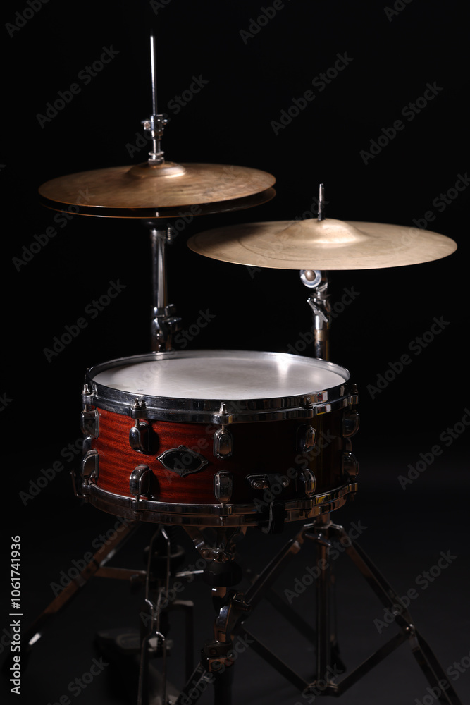 Fototapeta premium Different drums on a black background, percussion musical instruments