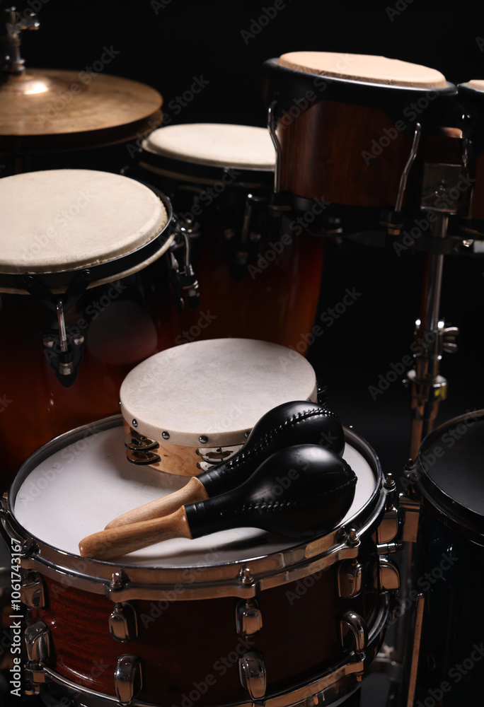 Different drums on a black background, percussion musical instruments Different drums on a black background, percussion musical instruments