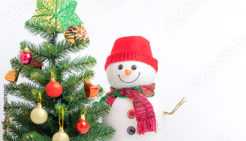 A snowman next to a Christmas tree decorated with Christmas ornaments background concept isolated white